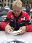 and she proudly puts on the Cologne MGF/TF natter sticker
